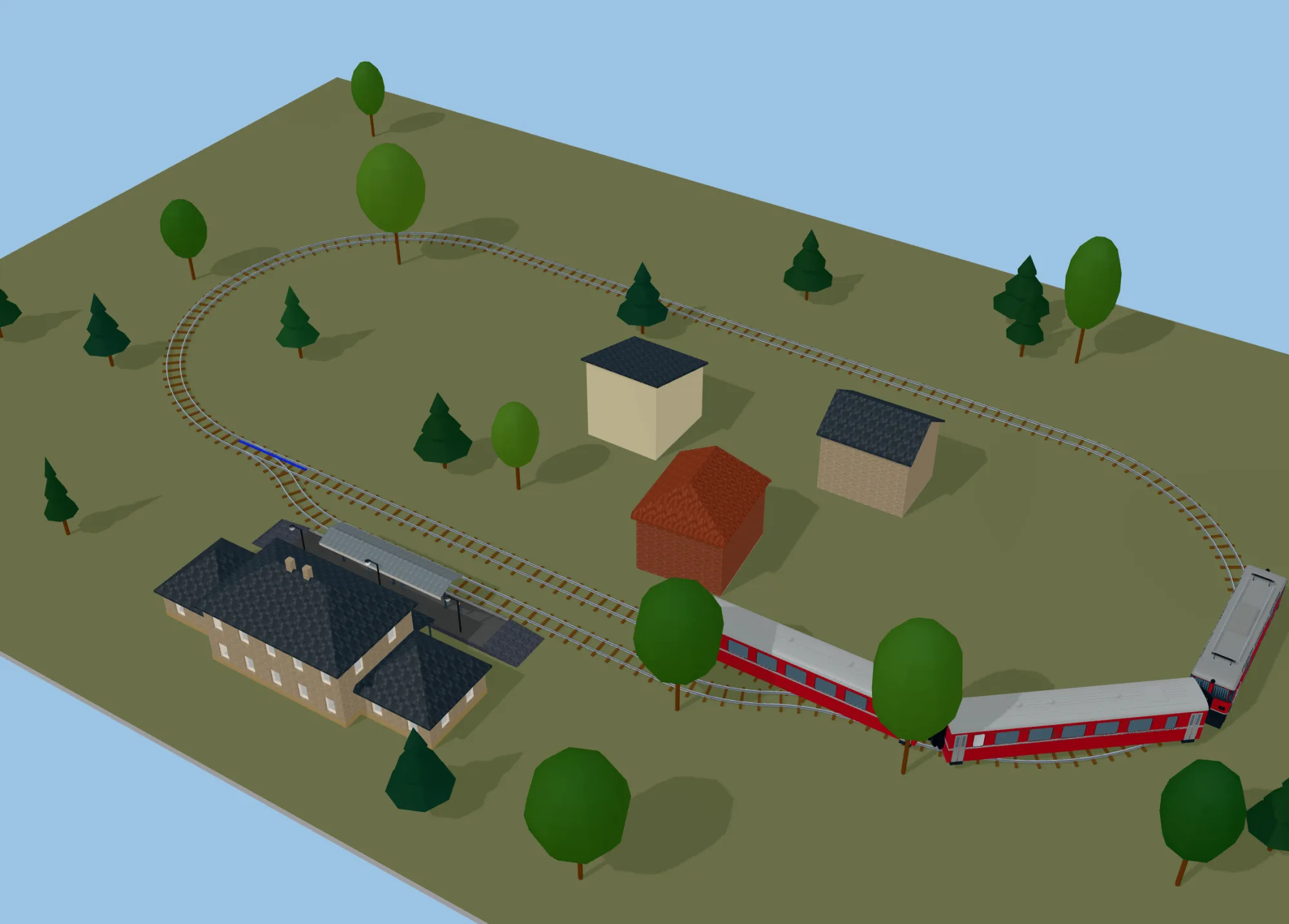 Le même ovale LGB avec une gare, des maisons et un train